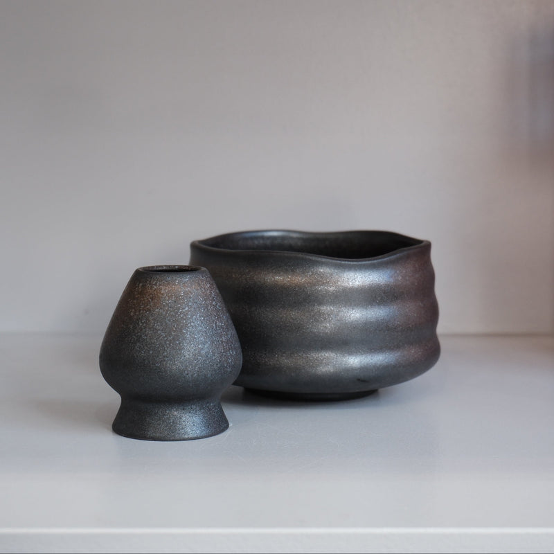 graphite matcha bowl with matching whisk holder showing subtle silver speckled glaze