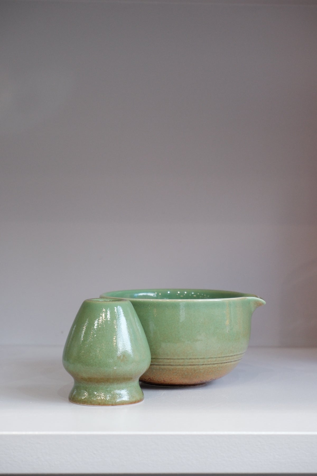 side view of green ceramic matcha bowl set showing pouring spout detail
