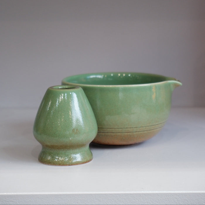 green glazed ceramic matcha bowl with pouring spout and matching whisk stand
