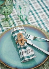 green wine glass styled with blue plate and checked napkin
