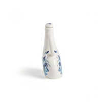 Classics on Acid HANA bottle styled on an eclectic dining table
