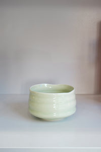 ceramic matcha bowl in pastel green showing finger grooves and handmade shape