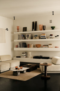 Harley vases by Olsson & Jensen on shelving in a living room
