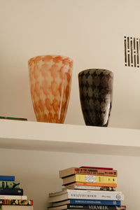 Harley orange and brown vases by Olsson & Jensen on a white shelf above books