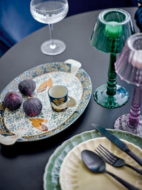 Hand-decorated Bloomingville Hezha espresso cup on patterned serving platter with figs and colourful glassware.
