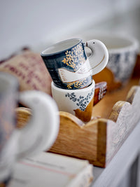 Bloomingville Hezha espresso cup stacked in a wooden tray showing detailed bird-shaped handle.