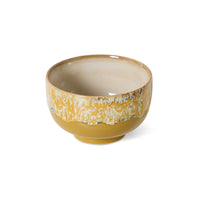 70s ceramics bowls and tableware styled together in warm yellow tones
