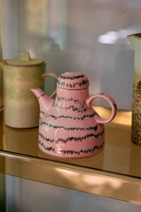 bubble pink HKLIVING coffee pot styled with other 70s ceramics on a shelf
