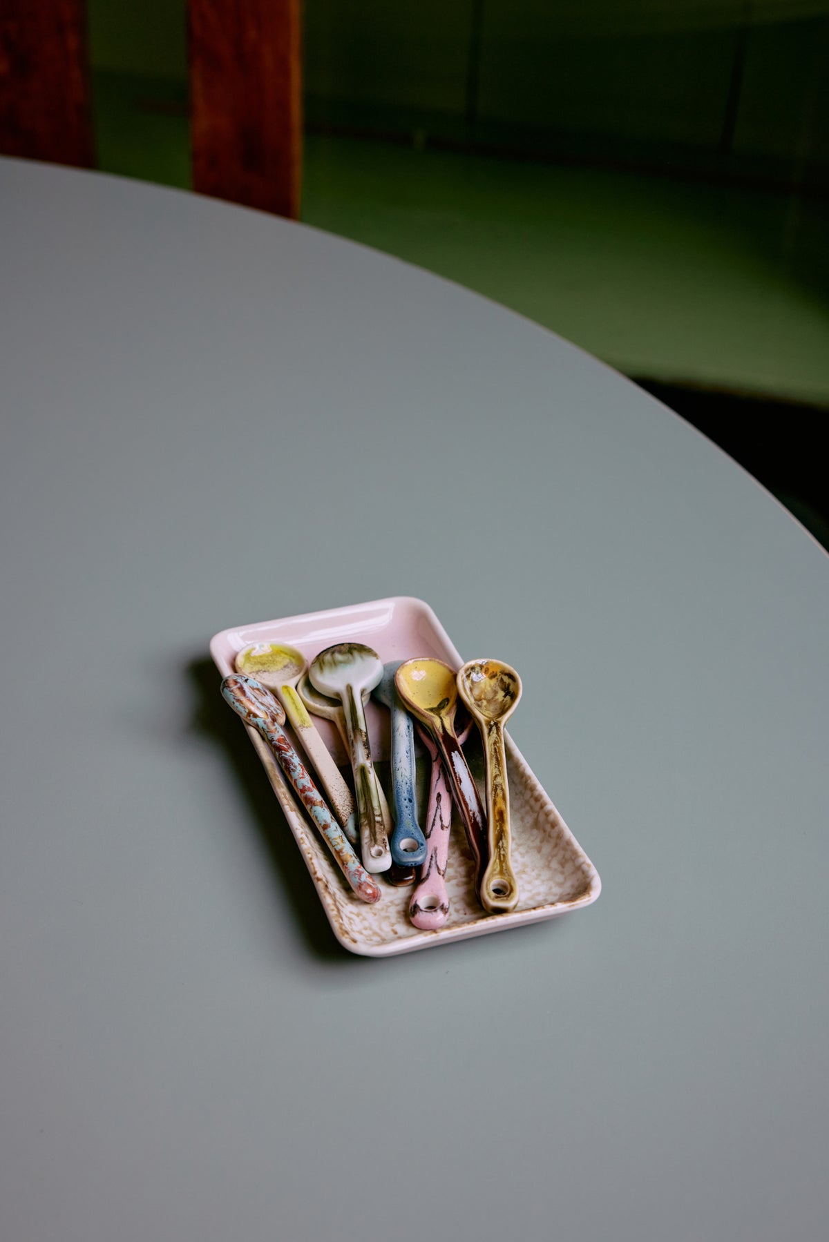 Assorted HKLIVING 70s Ceramics spoons styled in pink tray