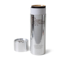 Open silver packaging with HKLIVING 70s ceramics candles – limited Frost & Firewood set
