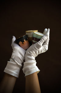 Three HKLIVING 70s ceramics mini candles held in white gloves – Frost & Firewood festive edition
