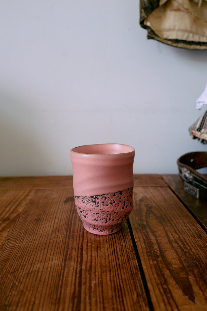 Smooth pink hkliving ceramic mug adding calm, tactile texture to a wooden breakfast table.
