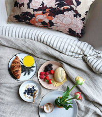 rectangular floral cushion on bed adding colour to calm bedroom
