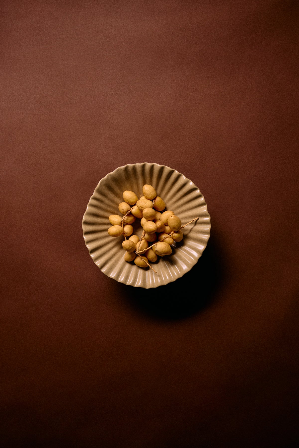 mokka beige pedestal ribble bowl by HKLIVING photographed from above with fruit for centrepiece inspiration
