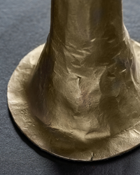 close-up of flared base with textured antique gold finish on House Doctor candle holder