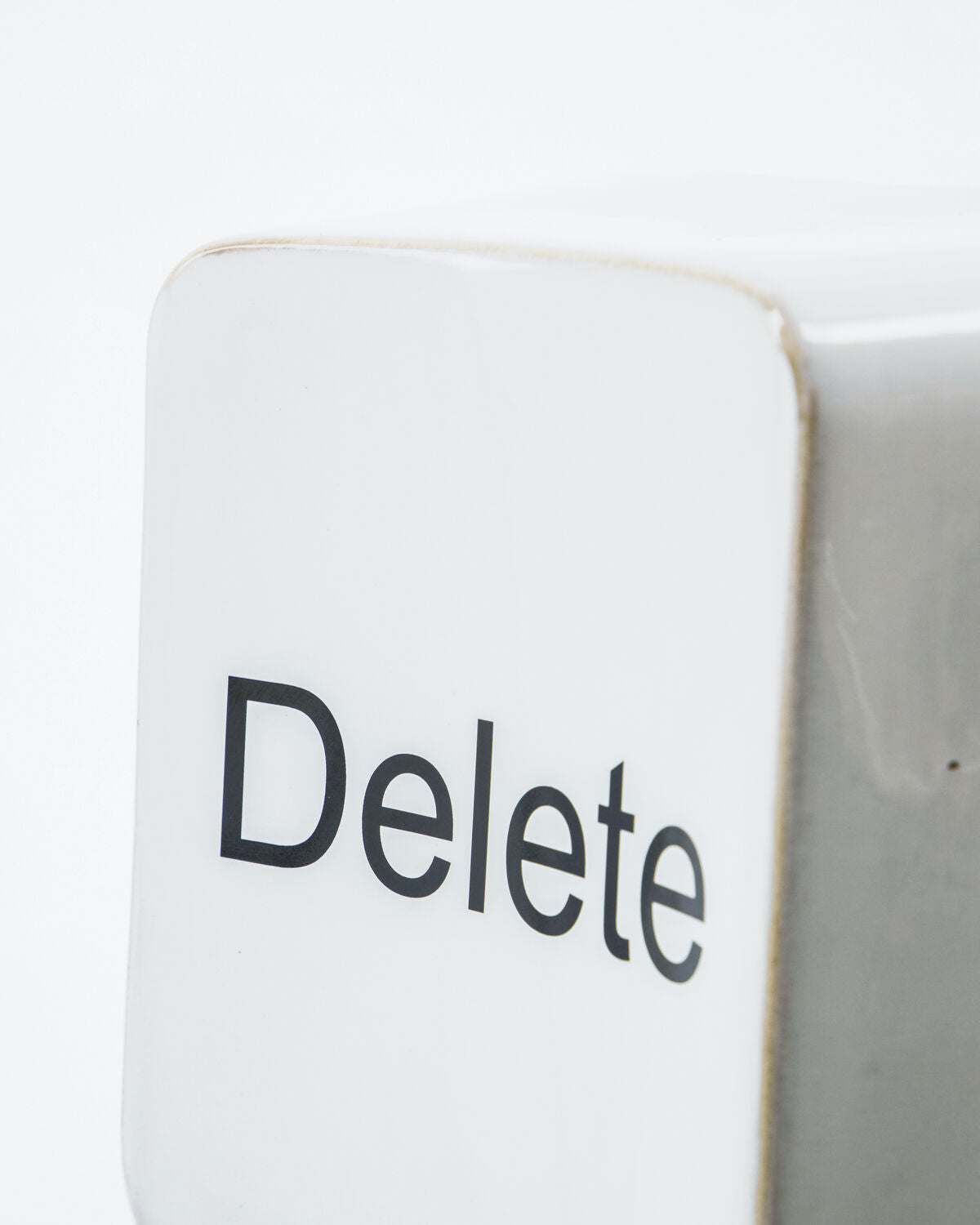 Close-up of the black Delete lettering and glaze on the House Doctor wall art