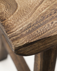 Close-up of the curved seat edge and wood grain on the House Doctor Lane bench