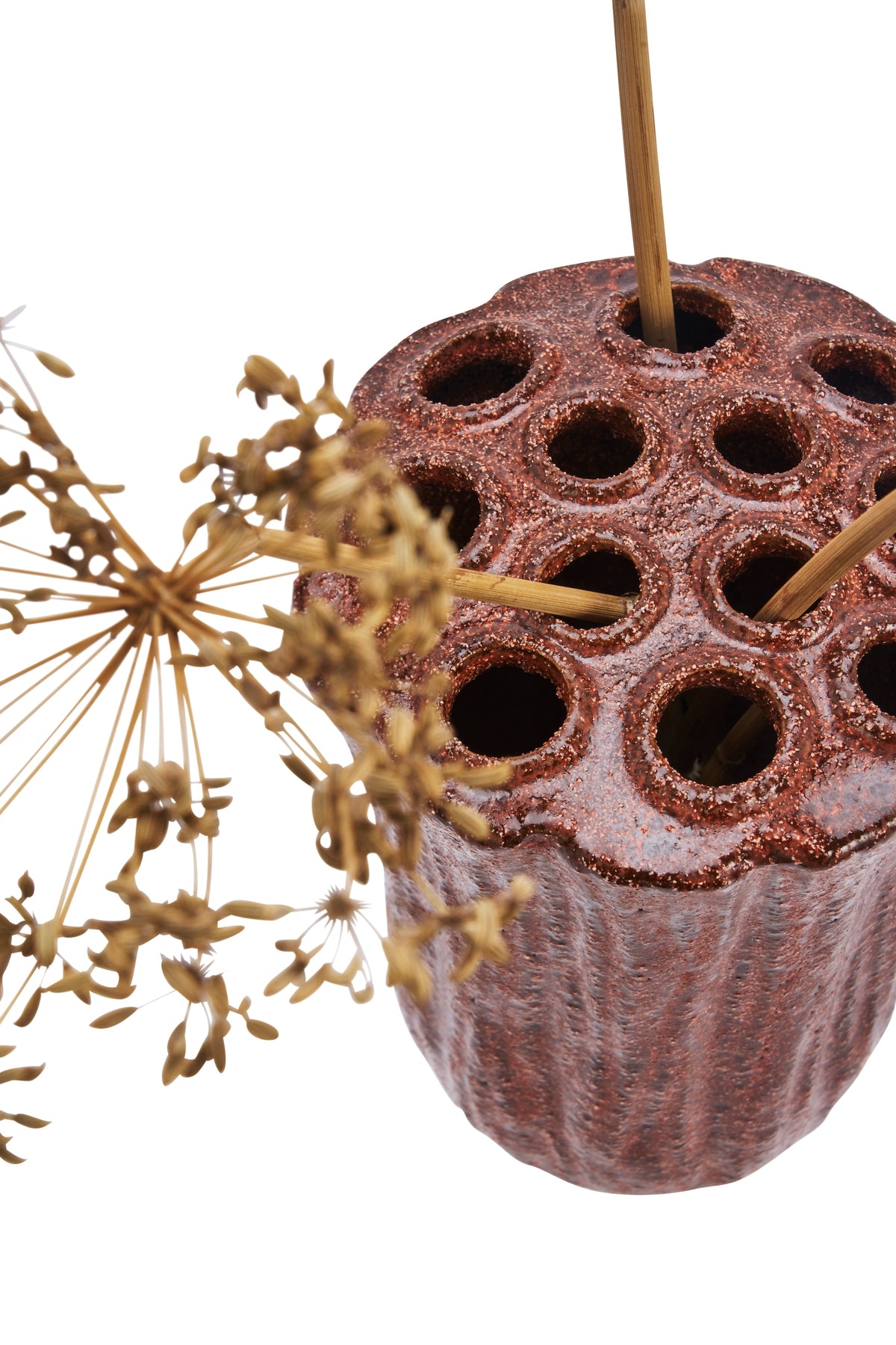 close-up of stoneware vase top showing multiple holes for stems
