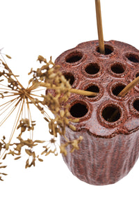 close-up of stoneware vase top showing multiple holes for stems
