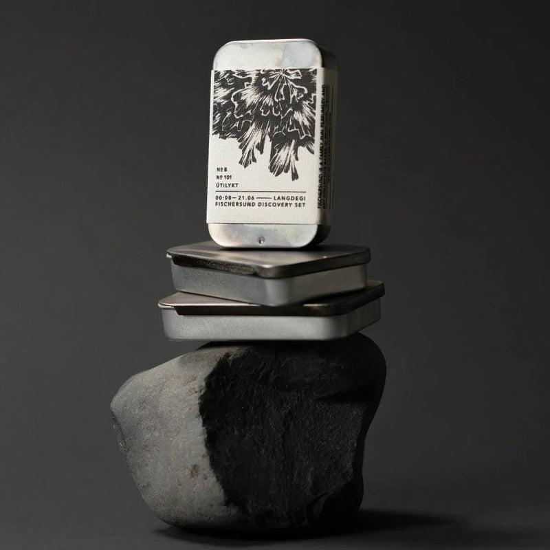 small stack of handmade fischersund light discovery sets stacked on a black rock