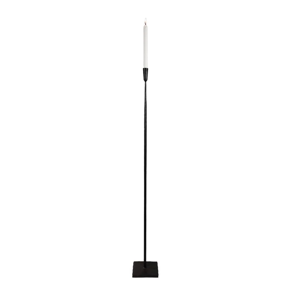 Ina tall black iron floor candle holder by Olsson & Jensen with a taper candle