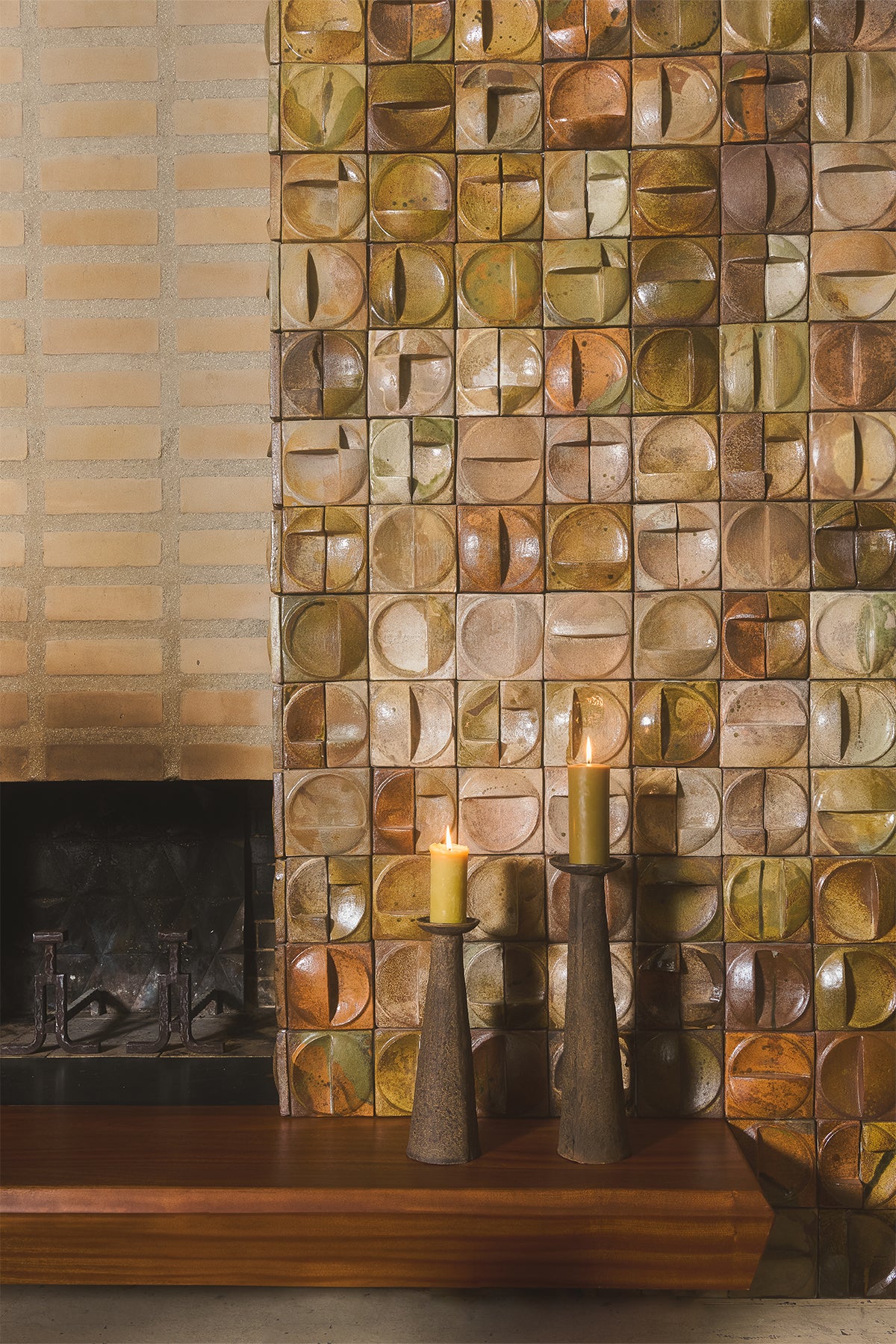 Indi candle holders by Olsson & Jensen grouped by a tiled fireplace