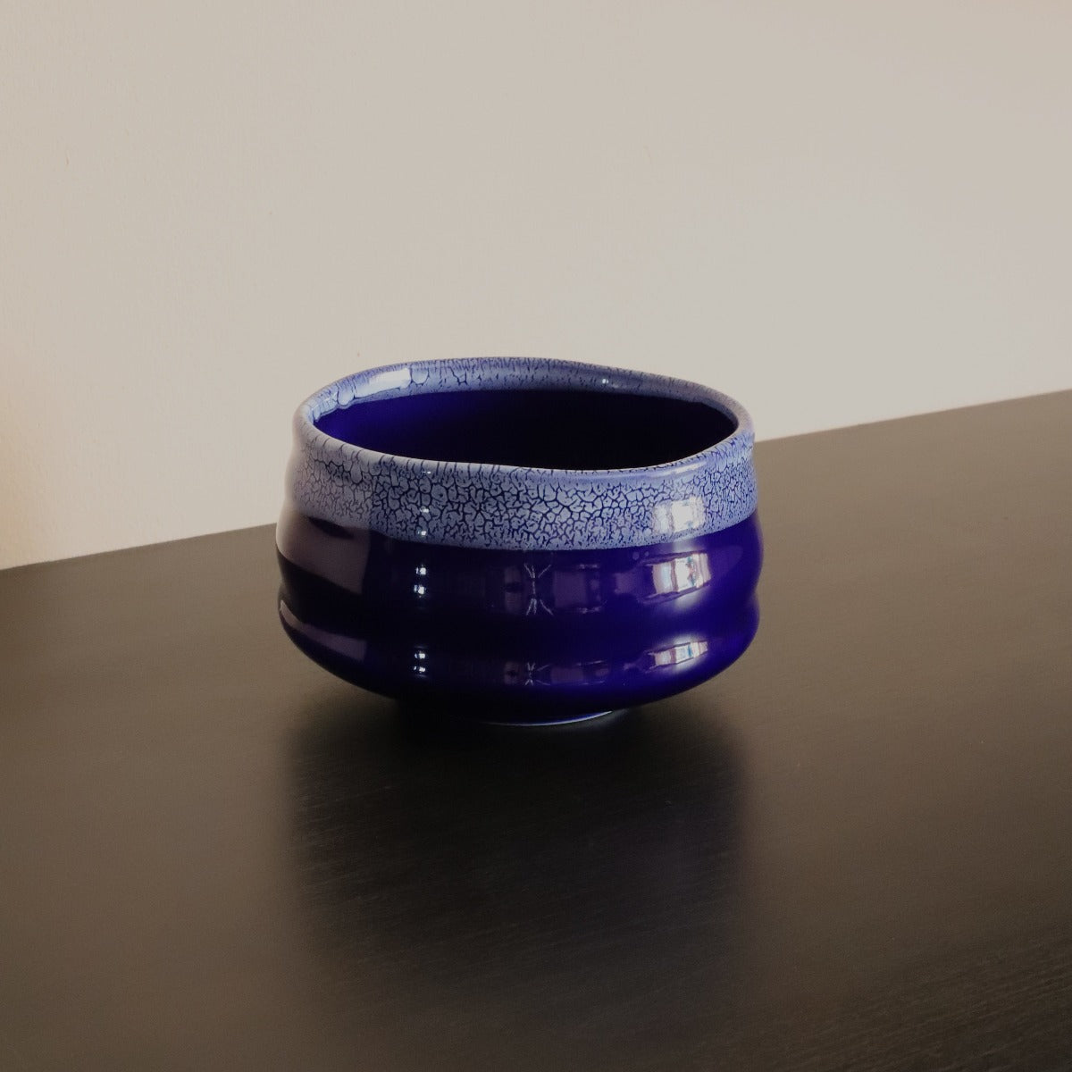 Handmade indigo matcha bowl in deep blue glaze with white crackle rim