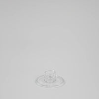 Isabella low round clear glass candle holder by Olsson & Jensen, empty, on a grey background