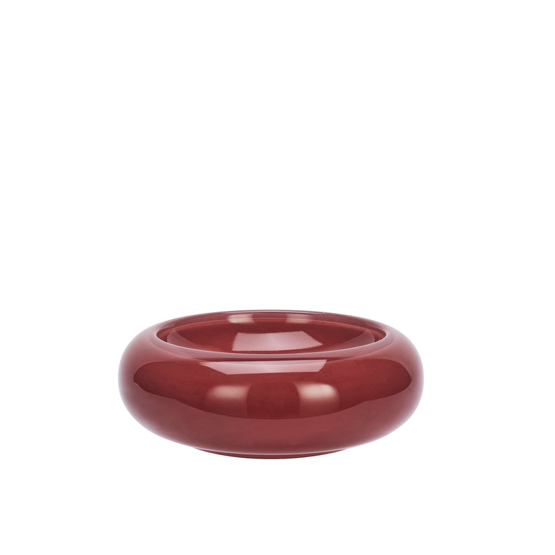 maroon round glass bowl with glossy curved design on white background
