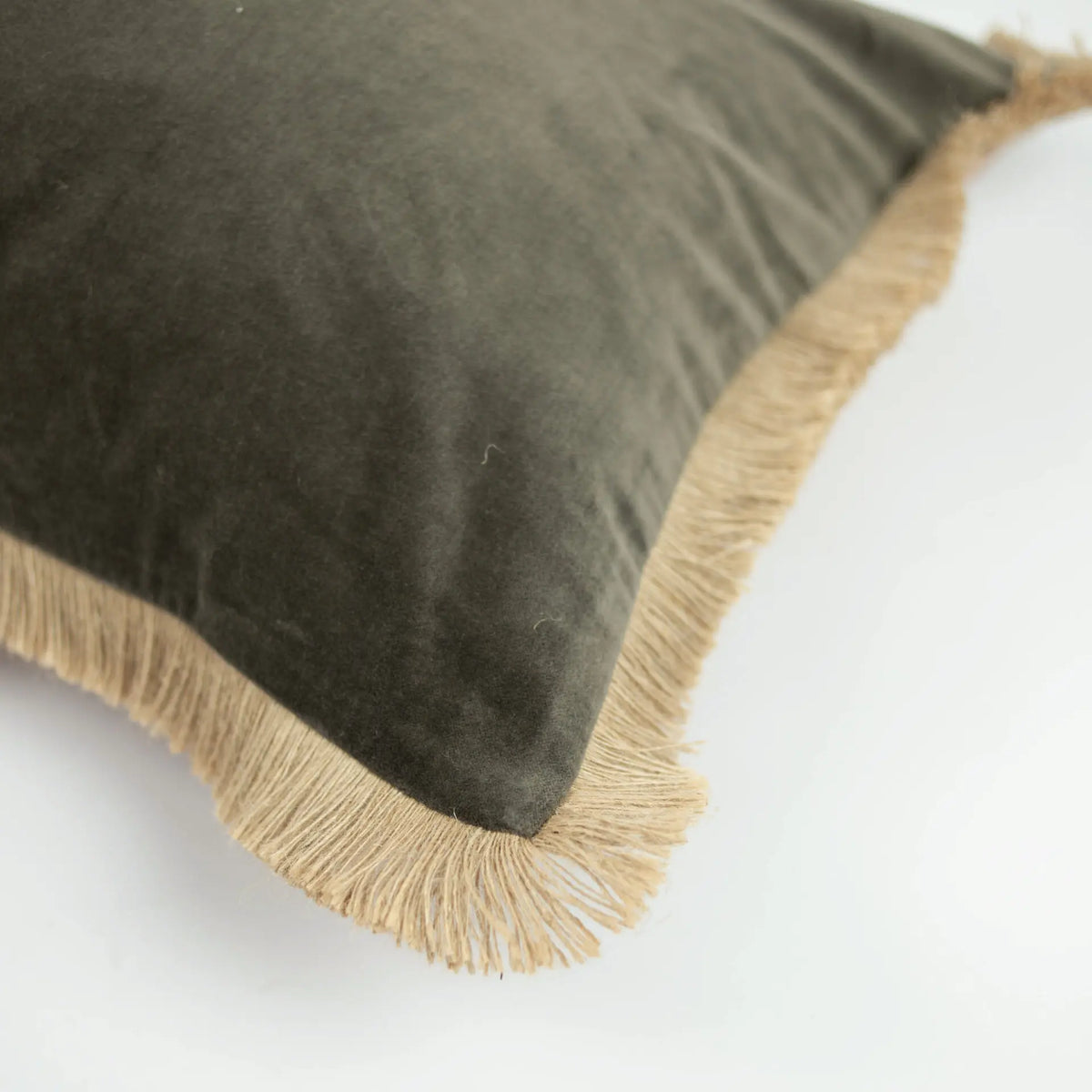 Corner detail of the olive side and jute fringe on the Julie cushion by Olsson & Jensen