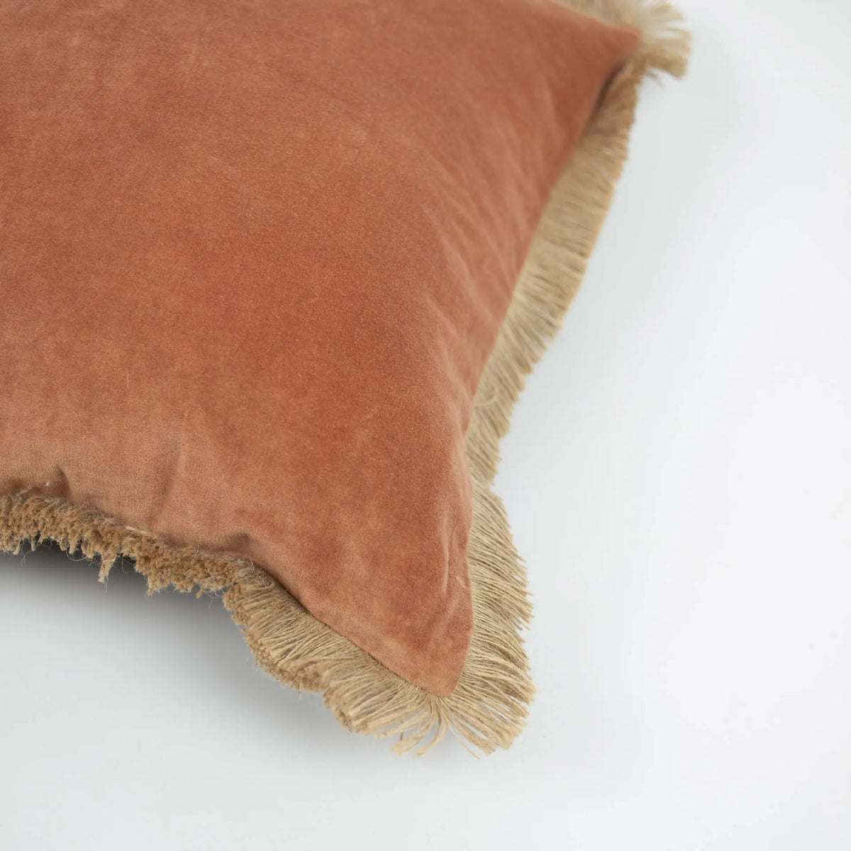 Corner detail of the rust side and jute fringe on the Julie cushion by Olsson & Jensen