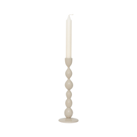 Juna candle holder with an ivory dinner candle