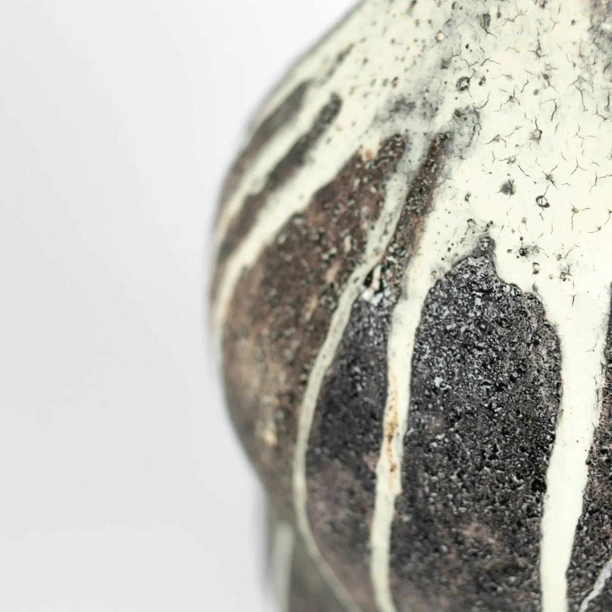 Close-up of the dark speckled drip glaze on the Kenzo ceramic object by Olsson & Jensen