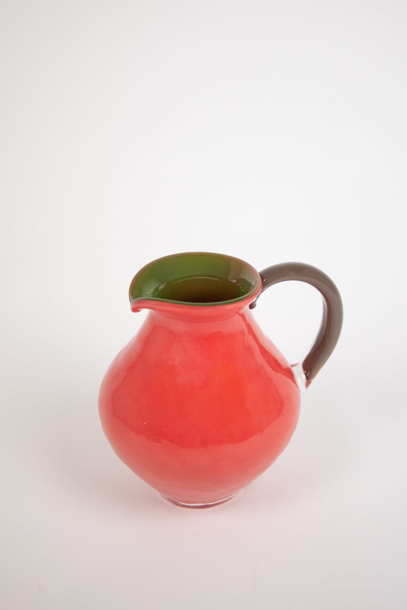 Kiko coral pink glass jug with a green inside and brown handle by Olsson & Jensen