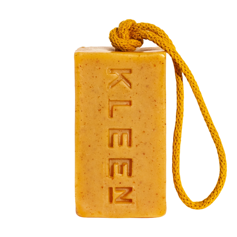Yellow Mellow turmeric soap on a rope by KLEEN, a yellow bar with exfoliating flecks hanging from a yellow cotton rope