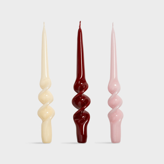  set of three &klevering candle alpha spiral tapers in cream red and pink
