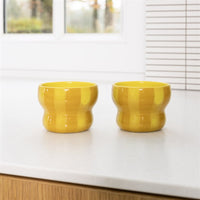 set of two &klevering circus large yellow mugs styled on a modern kitchen worktop
