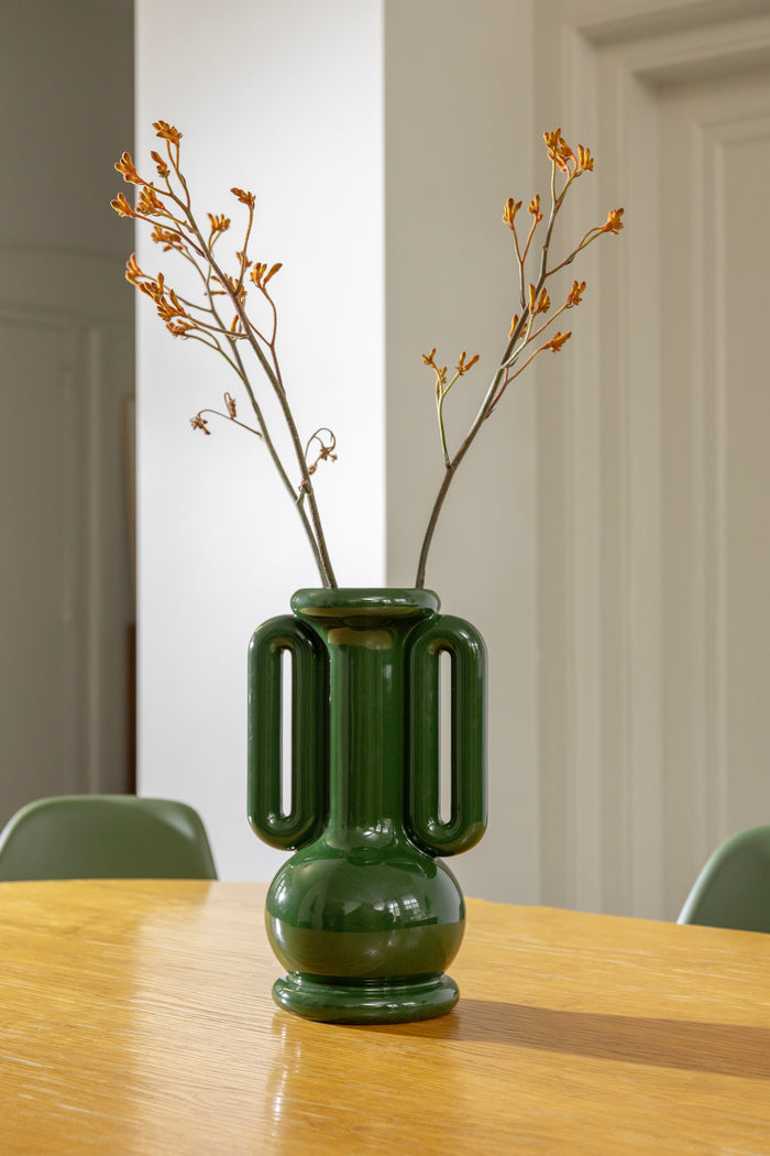 Tall green stoneware vase inspired by Greek amphora design styled on a table with twigs