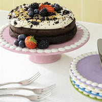 close-up of &klevering pink pedestal cake platter showing white whipped rim detail
