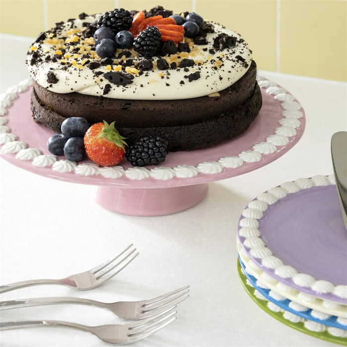close-up of &klevering pink pedestal cake platter showing white whipped rim detail
