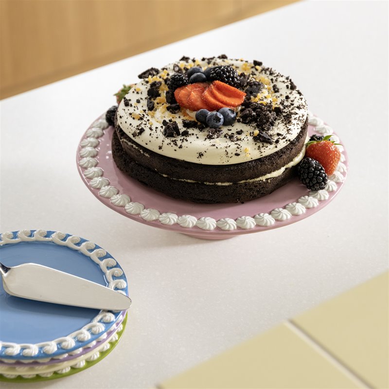chocolate layer cake topped with berries on &klevering whip pink cake stand with matching plates
