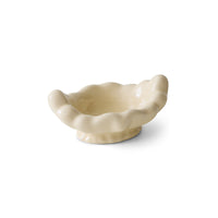 White ceramic shell-shaped bowl on a white background