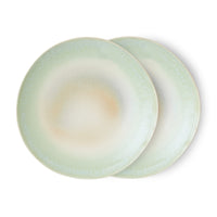 Stacked ceramic dinner plates with soft coastal colour palette