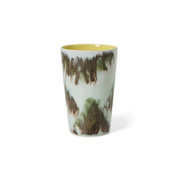 Studio shot of the HKLIVING Tide tea mug on a white background, showing its mint-white glaze with olive-brown drip detailing and yellow interior