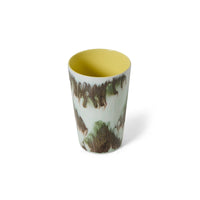 Angled studio view of the HKLIVING Tide tea mug on a white background, looking down into the yellow interior glaze