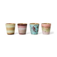 The full set of four HKLIVING Futurism ristretto mugs lined up on a plain white background, showing the range of hand-painted glazes