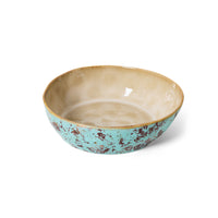 Angled view of the 70s Ceramics pasta bowls in Patina, showing the turquoise, rust-speckled glaze and warm tan interior