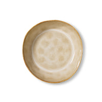 Top-down view of a 70s Ceramics pasta bowl in Patina, showing the mottled tan and cream glazed interior