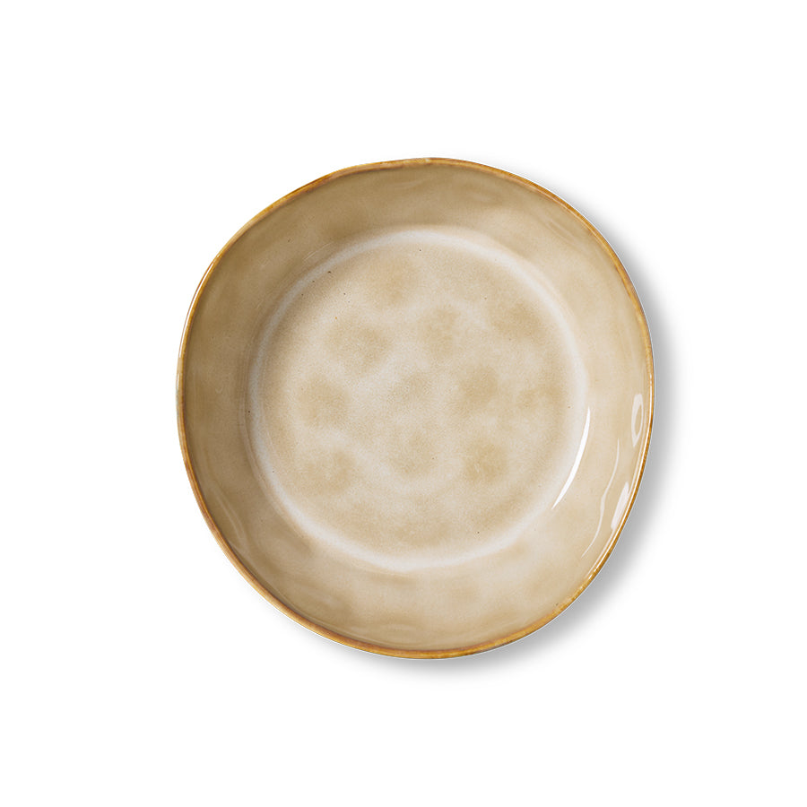 Top-down view of a 70s Ceramics pasta bowl in Patina, showing the mottled tan and cream glazed interior