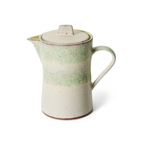 Front view of the 70s Ceramics teapot in Slush, showing the mottled sage green glaze band over a cream stoneware body